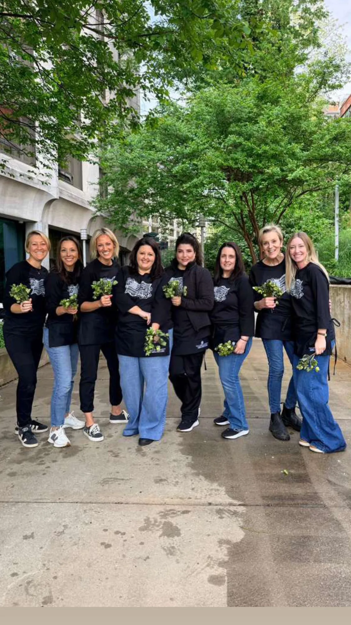 The CGaia crew in matching studio shirts gathered outside a venue before an install.