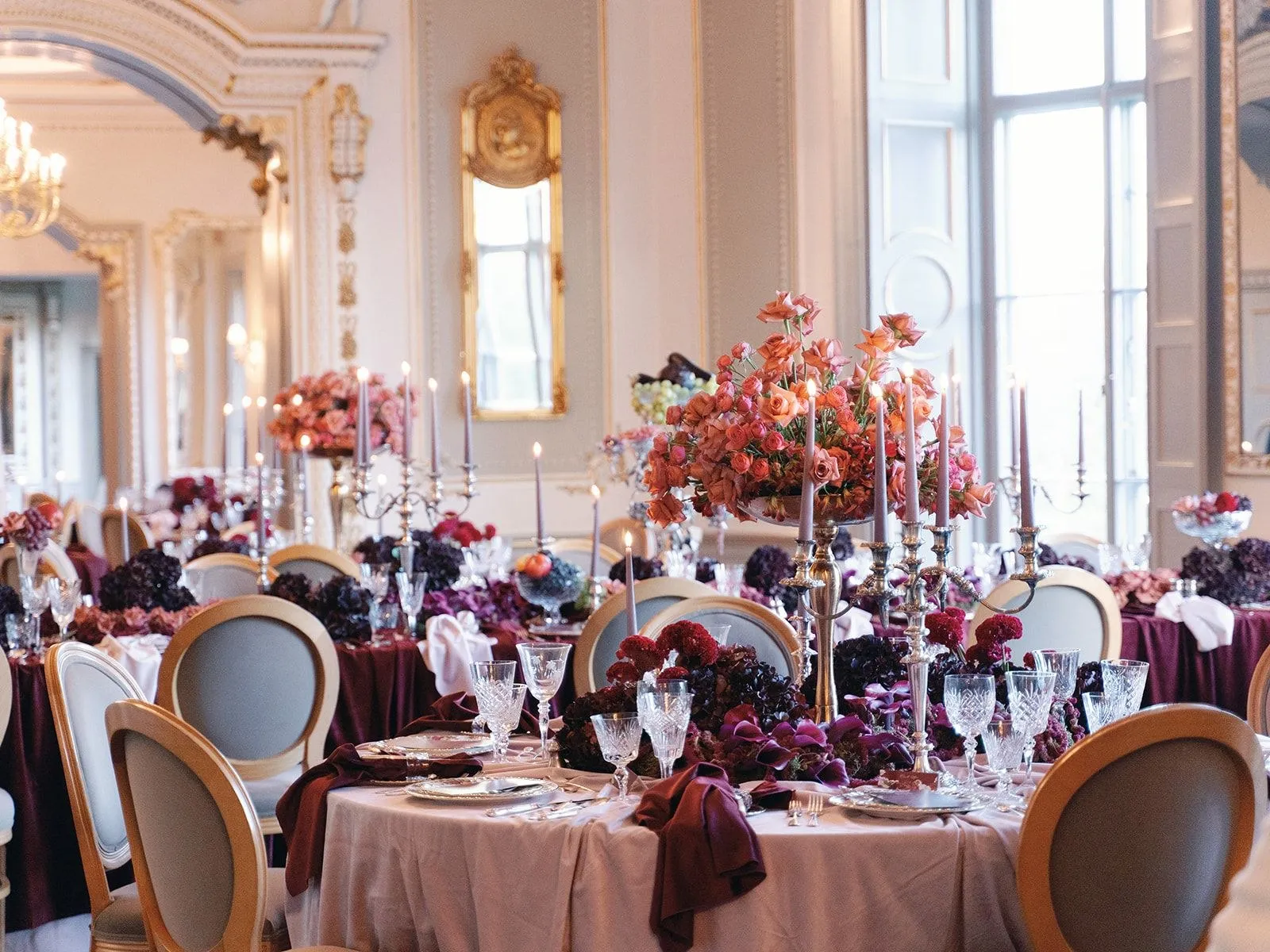 Gala ballroom dressed with candlelight and florals.