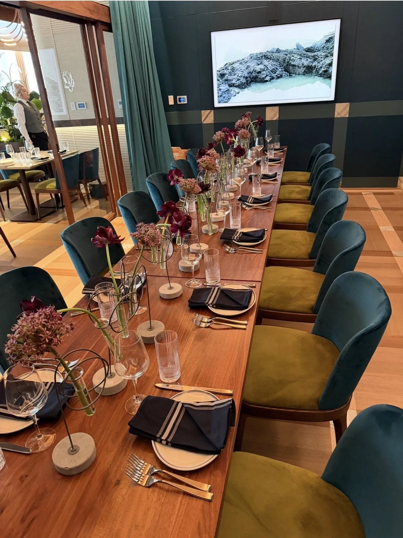 Private dining room with garden florals down a long walnut table.