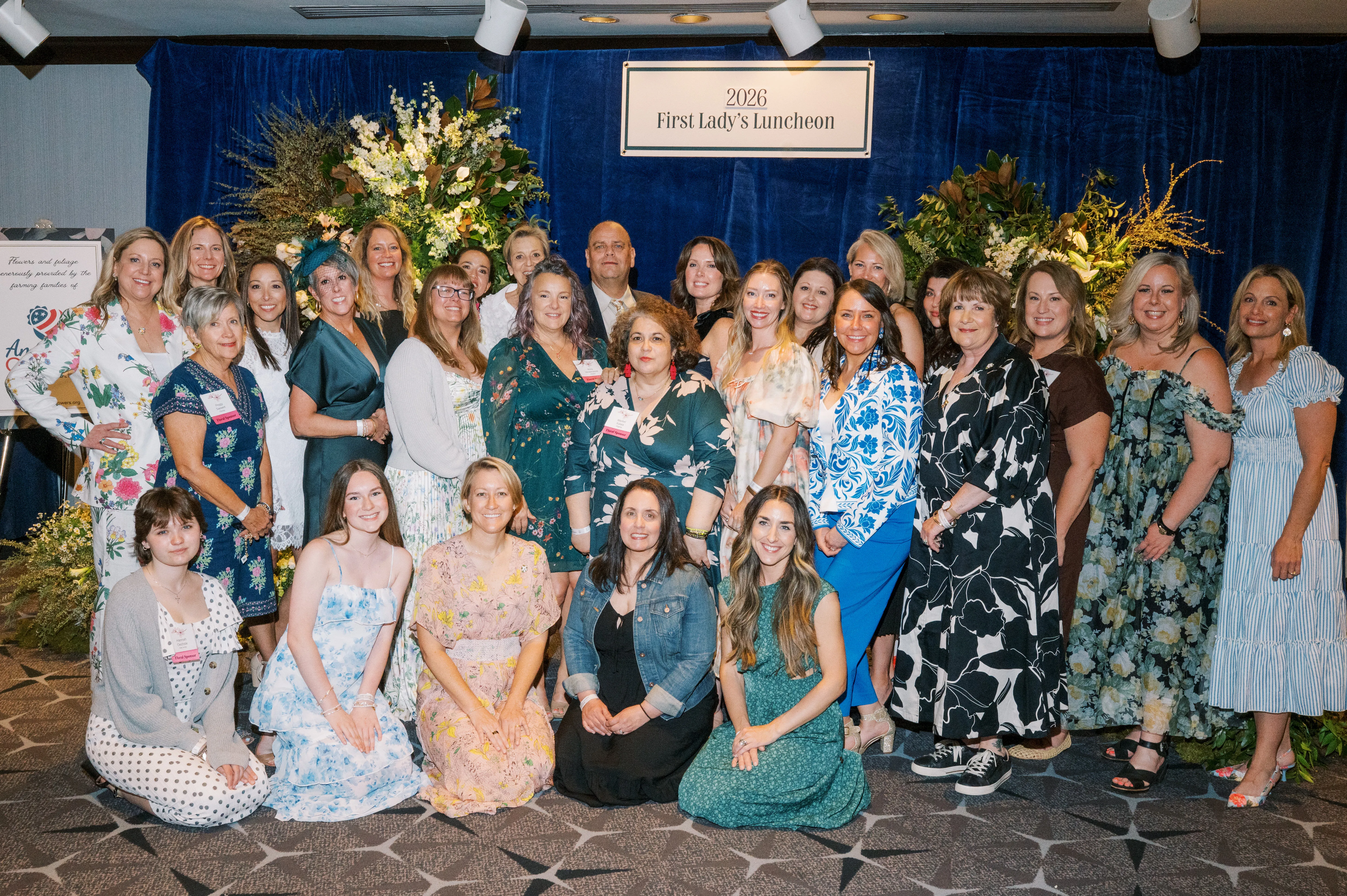 Floral design team gathered beneath greenery installations at the 2026 First Lady's Luncheon.