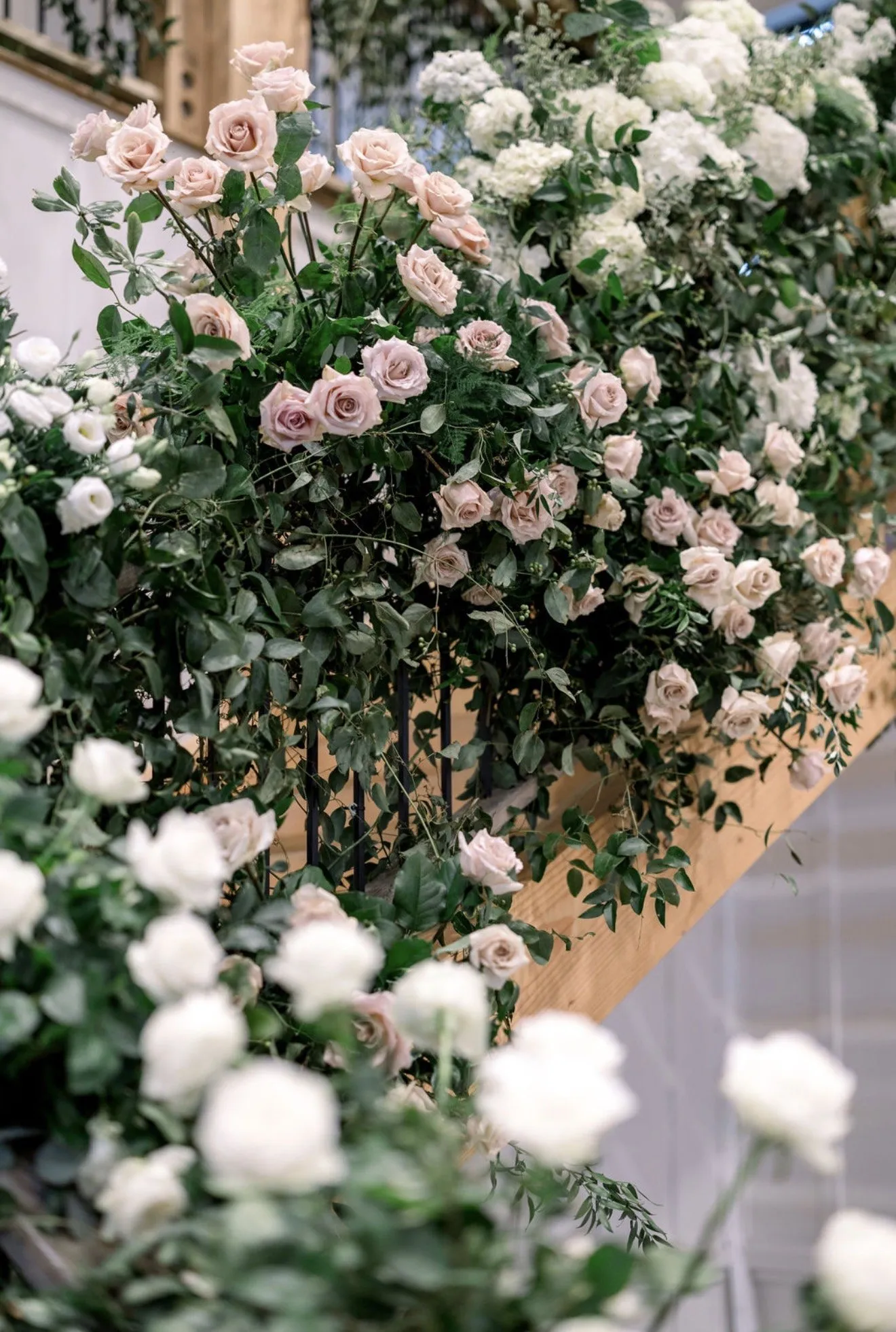 Blush garden roses climbing a staircase banister.