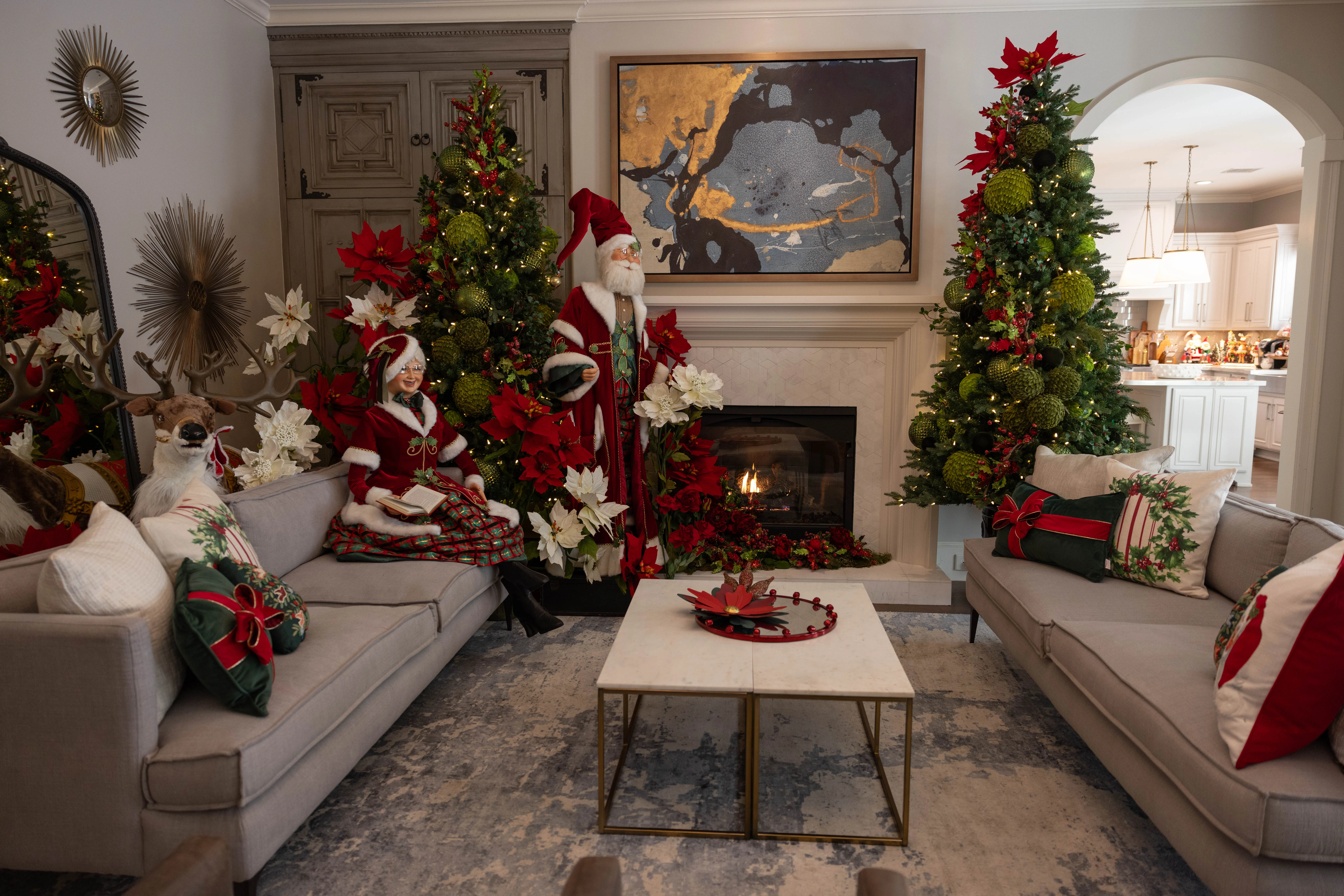 Twin decorated Christmas trees flanking a living room fireplace.